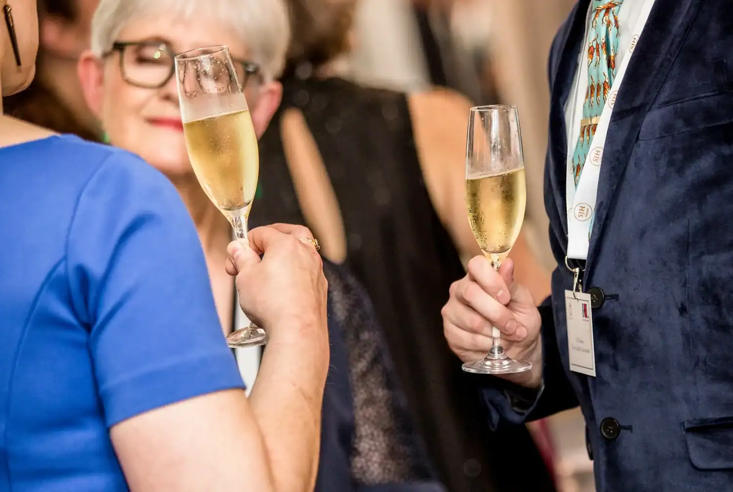 Heroes of the kitchen, they gather with champagne glasses in hand, toasting to their culinary adventures at this lively social gathering.