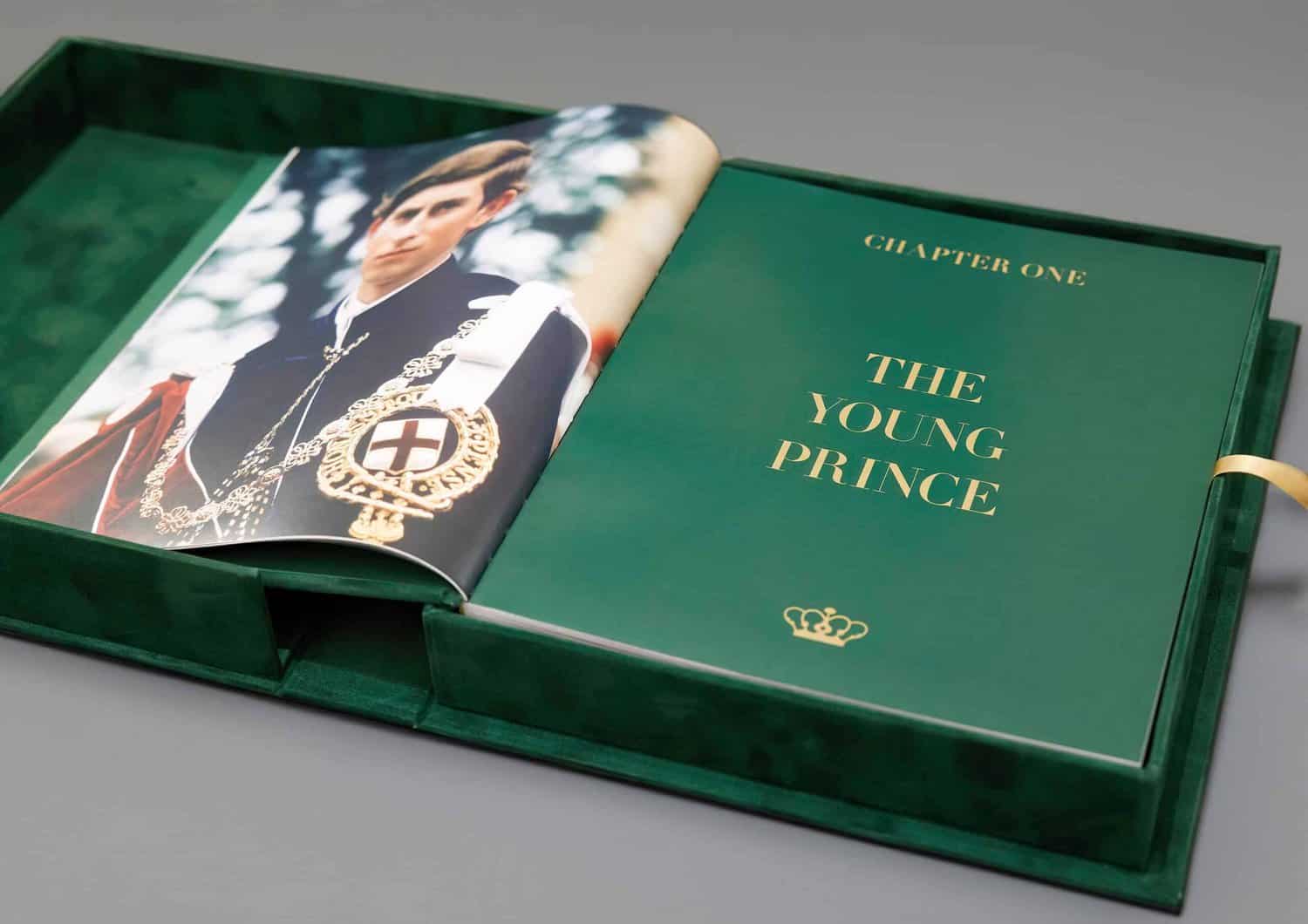 A book features an image of a young person in formal attire on the left page, reminiscent of King Charles III. The right page, titled "Chapter One: The Young Prince," is elegantly enveloped by a green velvet cover.