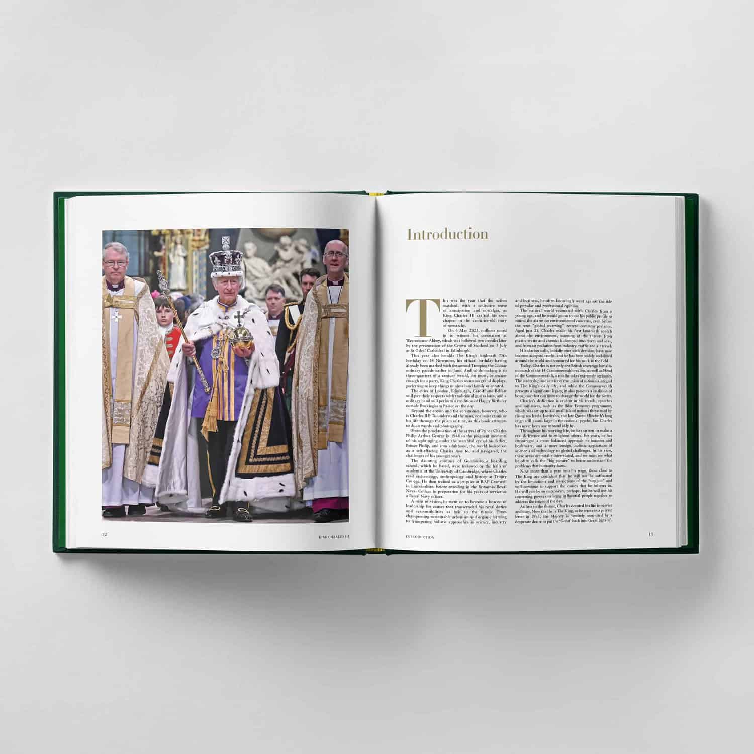 An open book reveals a photograph of King Charles III at a ceremonial event, surrounded by robed individuals. The adjacent page is titled "Introduction," offering insight into the significance of the occasion.