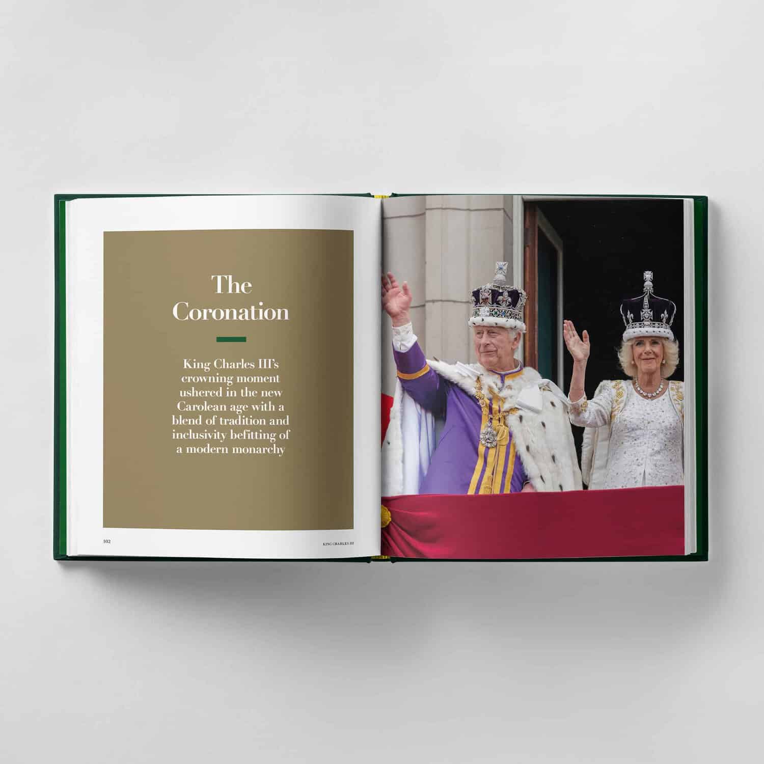 An open book reveals a captivating photo of King Charles III alongside a woman in royal attire, with "The Coronation" elegantly scripted on the left page.