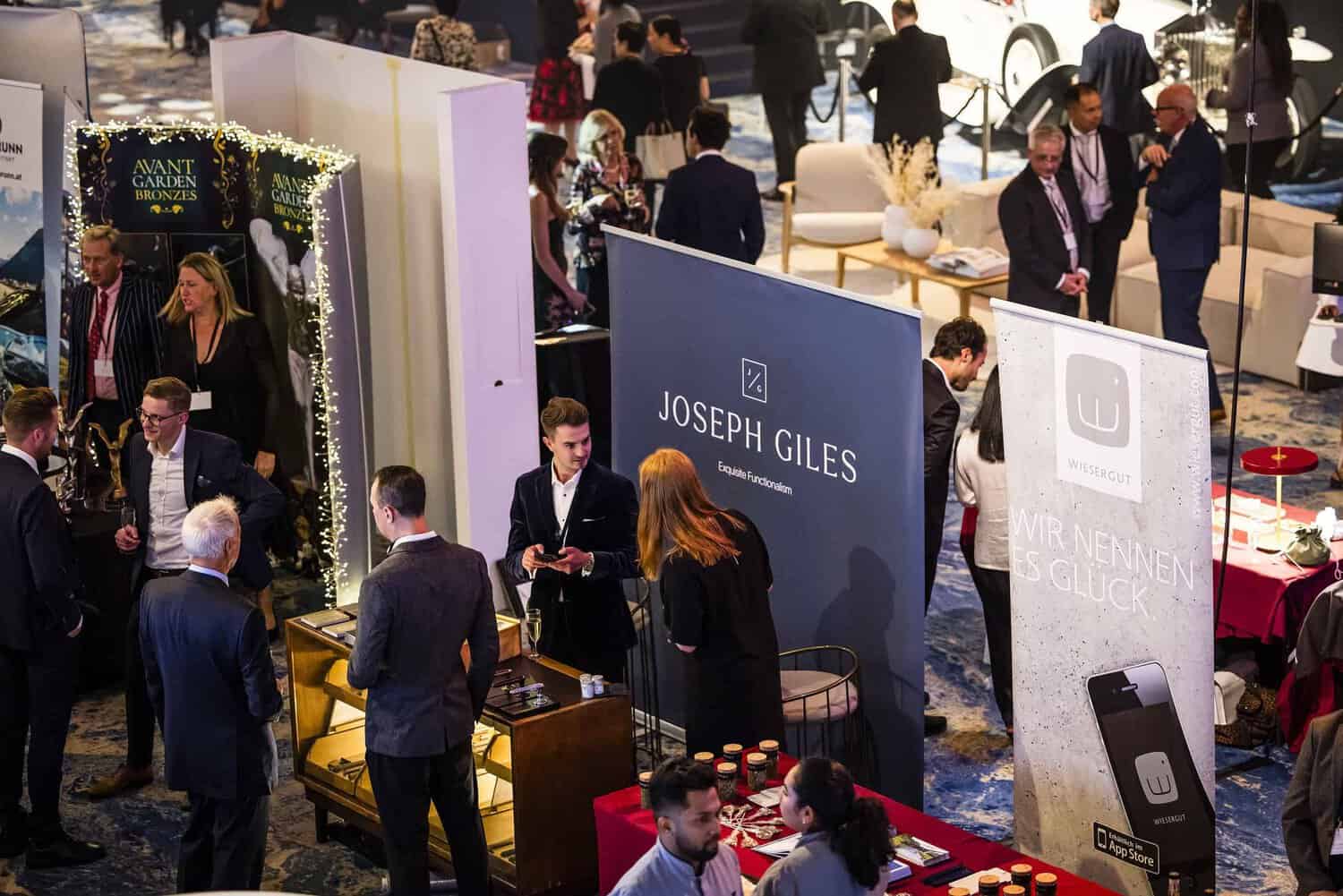 Amidst an indoor event bustling with booths, banners, and promotional displays, people network with a shared ambition to strive for perfection.