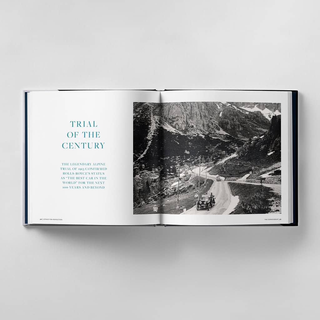 An open book reveals a historical photo of a car navigating a mountain road, accompanied by the title "Trial of the Century" on the left page, capturing a moment where excellence strives for perfection in every curve and turn.