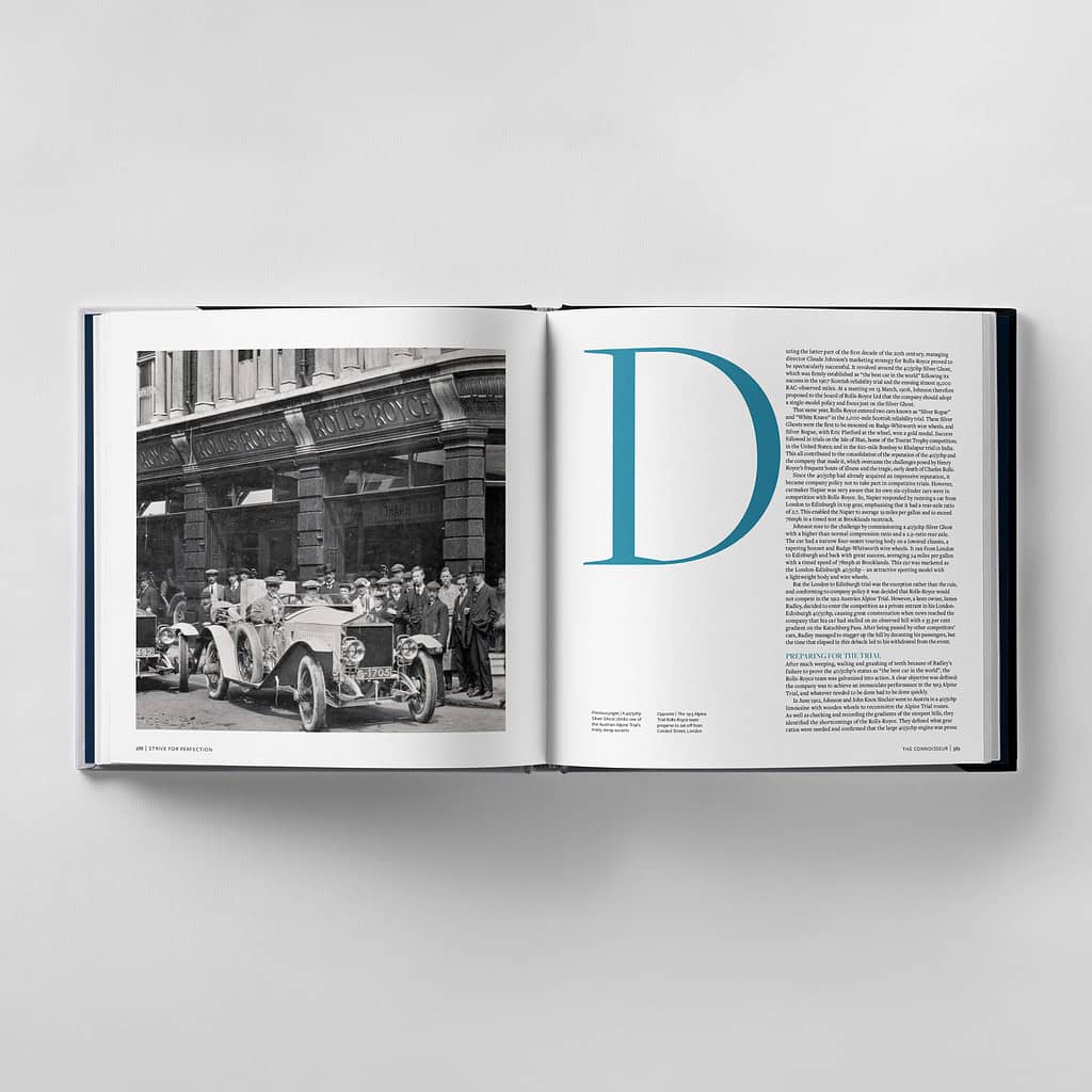 An open book displaying a vintage car photo on the left page and, on the right, a large blue letter "D" accompanied by text that embodies the essence of striving for perfection.