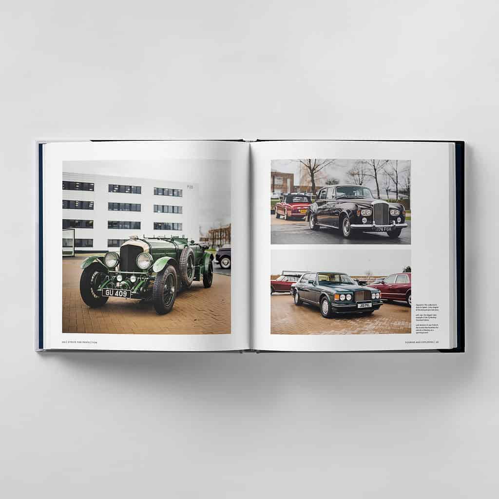 An open book showcases photographs of vintage cars, striving for perfection with a green classic car on the left page and several other timeless vehicles on the right, against the backdrop of a modern building.