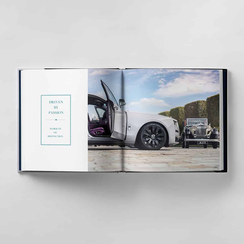 Open book displaying a luxury car with its door open on the right page, and an older classic car in the background. Left page reads: "Driven by Passion, Strive for Marques of Distinction, Achieving Perfection.