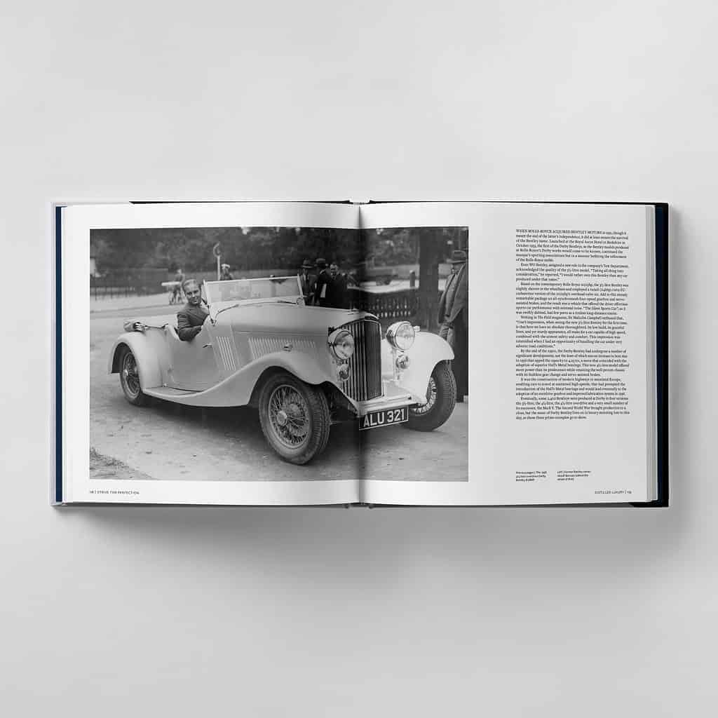 An open book reveals a black and white photo of a man driving a vintage convertible car, exuding perfection, with text gracing the opposite page.