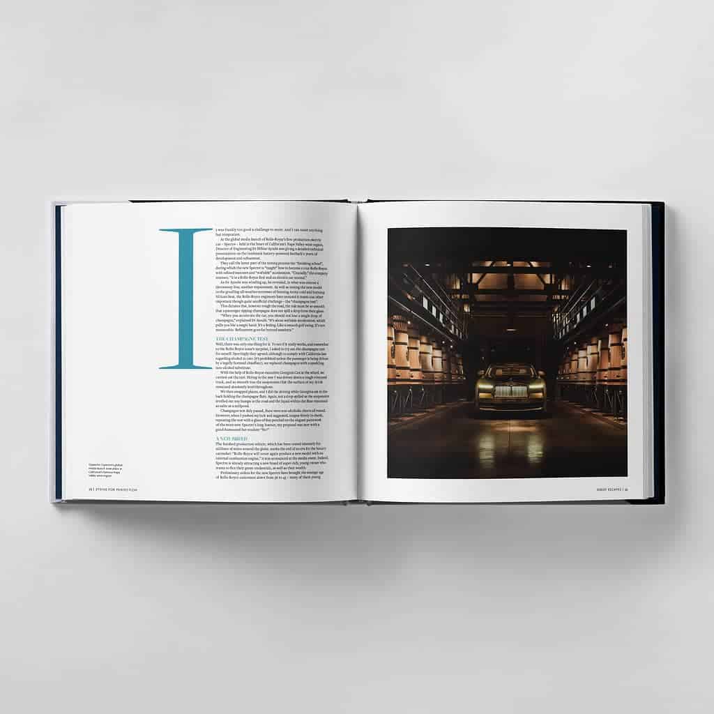 An open book reveals text on the left page, while the right page displays an image of a car in a dimly lit garage, embodying the pursuit to strive for perfection.