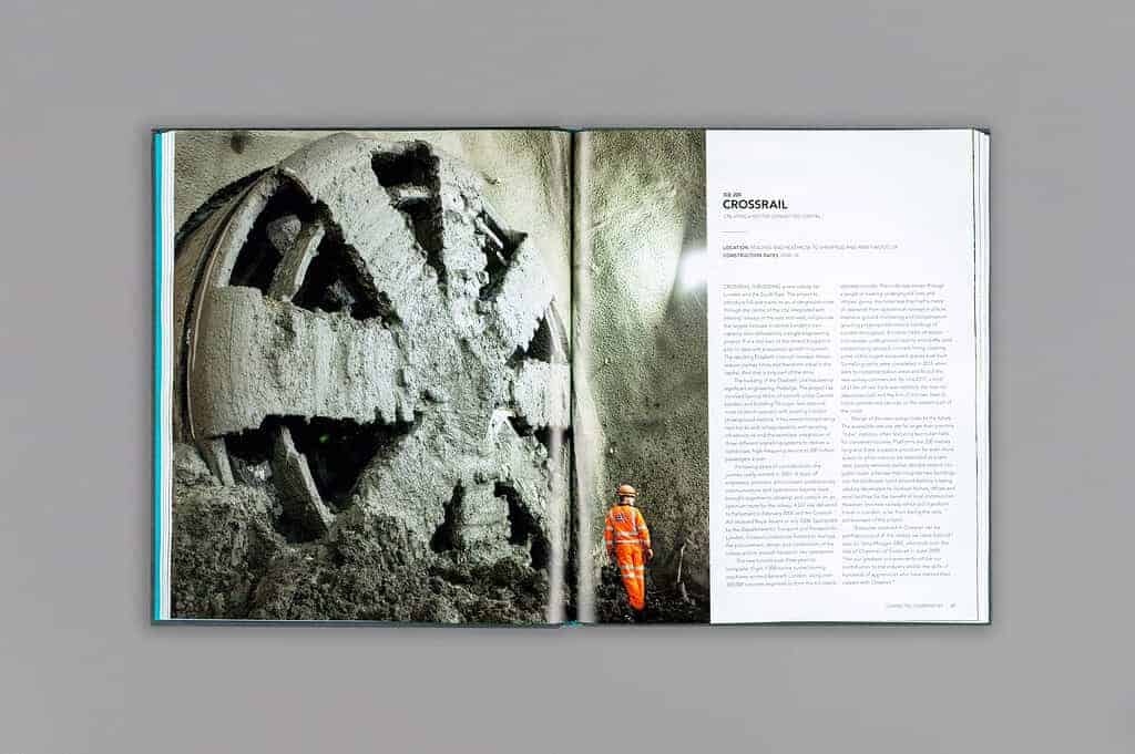 Open book reveals an image of a large tunnel boring machine and a worker in orange gear on the left page, with text on the right page under the heading "Crossrail: Shaping the World." This project highlights its global impact in transforming urban landscapes through innovative engineering.