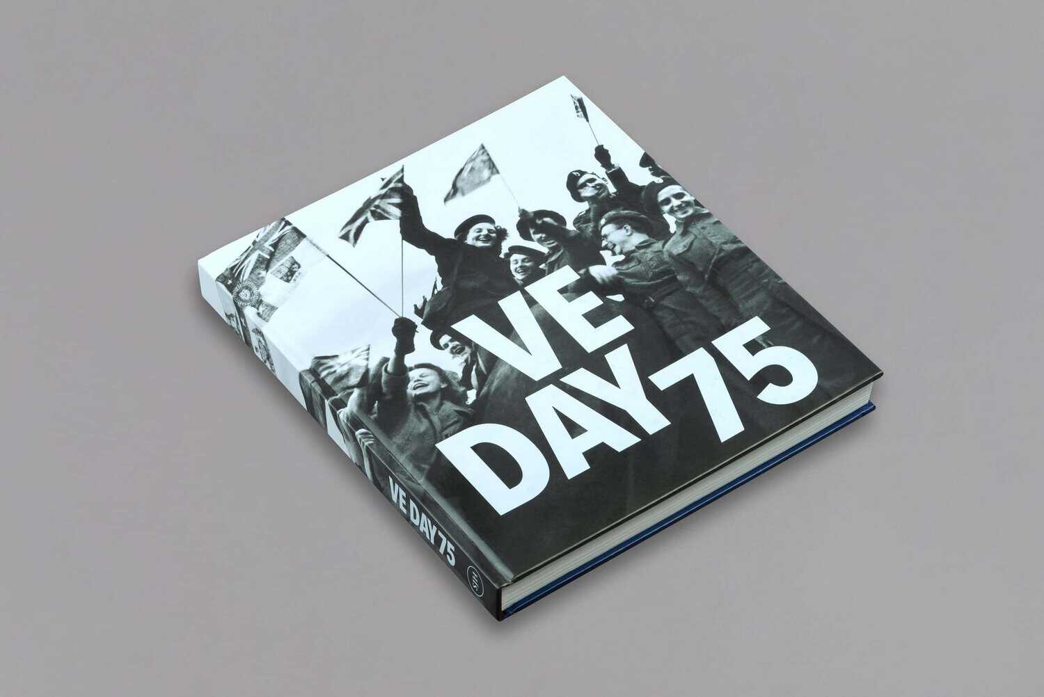 A book titled "VE DAY 75" with a black and white cover image of celebrating individuals holding flags, commemorating the 75th anniversary of Victory in Europe Day.