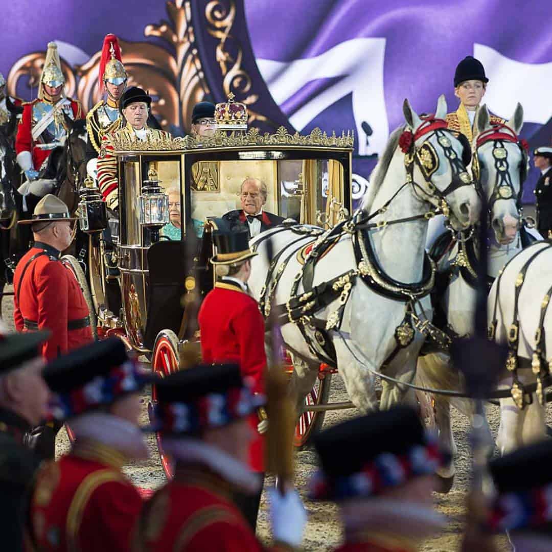 A majestic horse-drawn carriage, flanked by 90 guards in ceremonial attire, paraded with regal splendor reminiscent of a queen's grand procession.